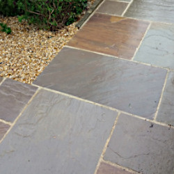 A garden path made from sandstone paving slabs
